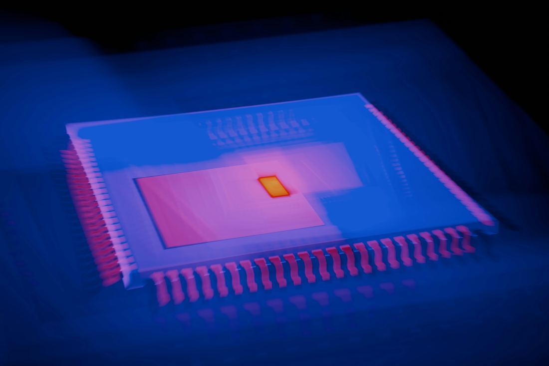 Close-up of a processor lit in blue and magenta
